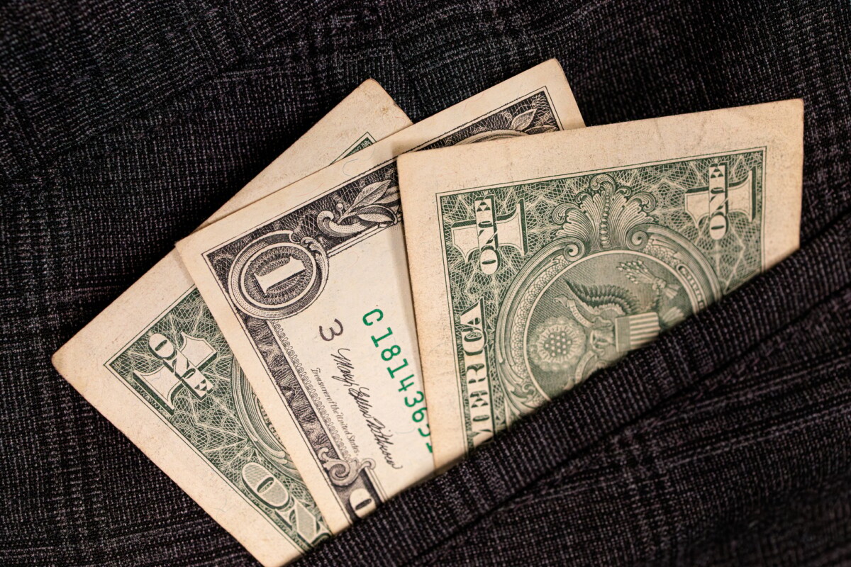 Dollar bills sticking out of your pocket.