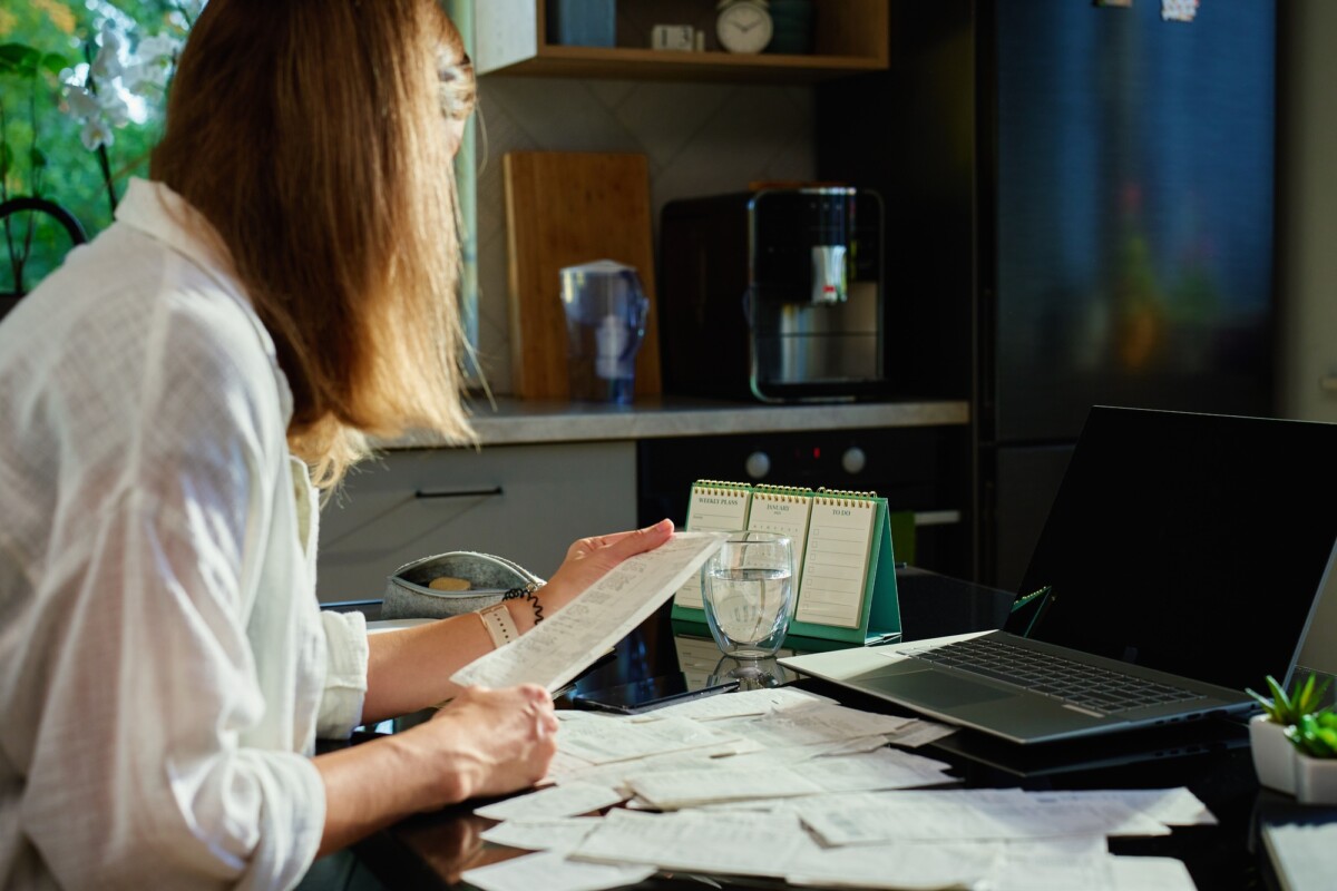 Stressed woman managing bills and finances at home