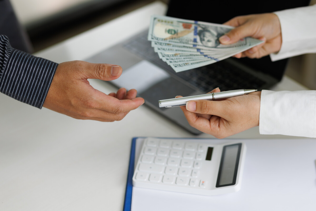 Business people get paid wages or salaries. Bribery signing concept.